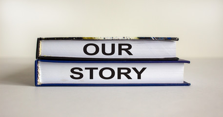 Books with the text 'our story' on beautiful white background. Business concept.