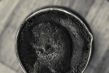 Natural coffee with thick foam, brewed in a copper cezve in the classical way, on a wooden...
