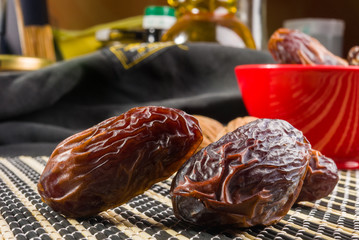 Big luxury dried date fruit on the bamboo mat, kurma ramadan kareem concept, close up.
