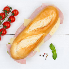 Sub sandwich baguette with ham and cheese square from above on wooden board