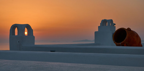 Sunlight during Santorini sunset across the fireplaces