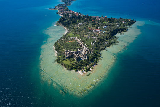 view at high altitude. Morning photography with drone. Archaeological site of Grotte di Catullo, Sirmione, Italy early morning aerial view. lake garda.