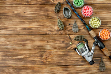 Accessories for carp fishing and fishing baits on wooden planks with copy space