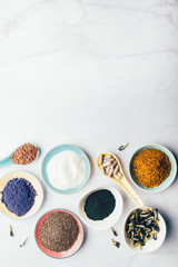 Variety of healthy food supplements such as blue matcha, butterfly pea flowers, collagen powder, spirulina powder, vitamins for vegans and vegetarians, flax and chia seeds,
