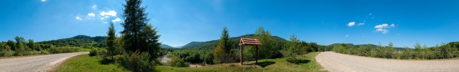 Fototapeta na wymiar Wooden bench near the alpine road in the Carpathians