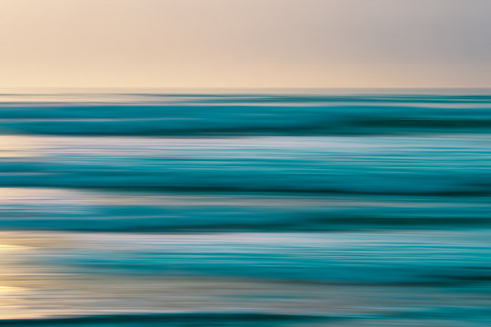 Abstract seascape background with blur panning motion in soft light blue, turquoise, pink and yellow colors, line art