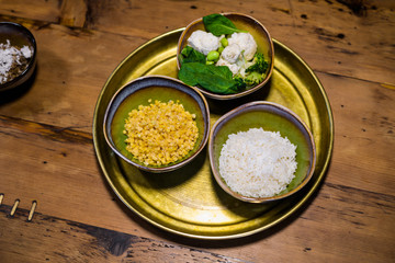 Asian style food, close up picture of ceramic bowls with jasmine rice, lentil and greens.