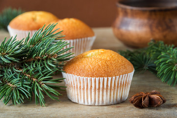 Delicious homemade Christmas pastries on a wooden table. Spruce branches and star anise. Selective focus.
