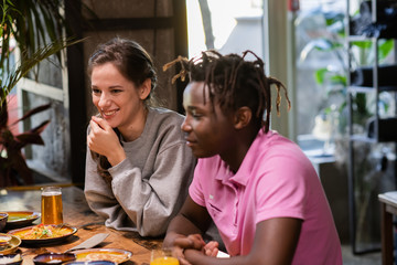 Happy young couple in cafe, having a great time with their friends. Close up shot.