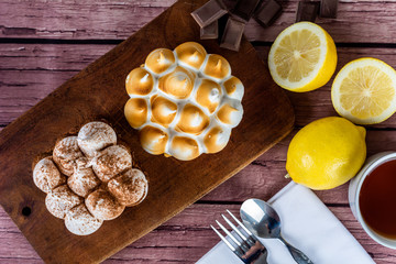 Mini chocolate and lemon pie cake with cup of tea.