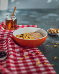 Granola bowl with nuts, raisins and honey