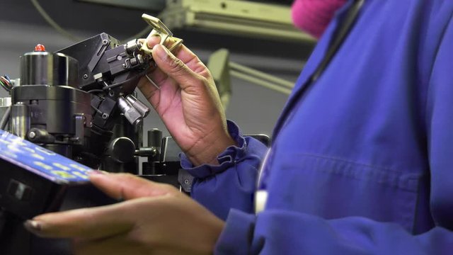 African worker operating a diamond bruting machine in a polishing factory