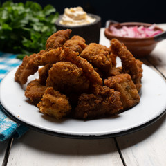 Fish chicharron with mayonnaise and onion on white background