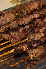 Tasty portion of beef on bamboo skewers. Ready to be savored. Beef skewers. Meat barbecue. Gourmet Photo.