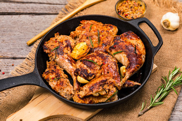 Braised Fried Rabbit with Rosemary, Garlic and Olive Oil on Wooden Background. Selective focus.