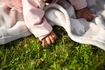 little child tears green grass, close-up of  hand