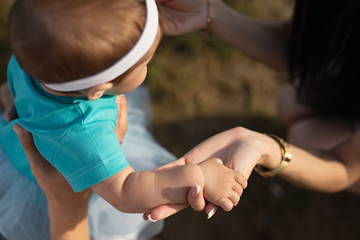  woman holds  child by hand, view from above, close-up of  child and hands