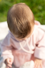 blurry image on top,  child sits and looks down