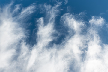 Beautiful view of white fluffy clouds in blue sky. Summer natural weather background