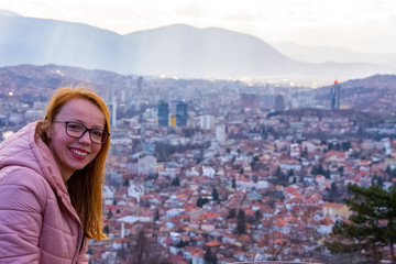 Girl smilling above the cityscape of Sarajevo capital of Bosnia and Herzegovina