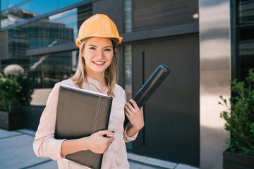 Professional architect woman standing outdoors.