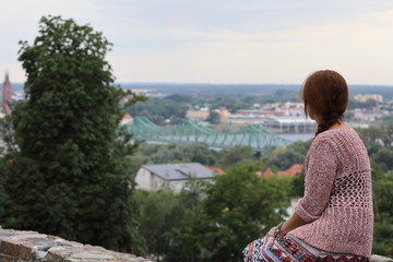 a woman looking down on the city of Włocławek,Poland