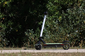 lonely scooter on the path in the park