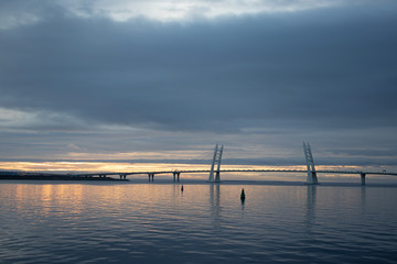 Fototapeta na wymiar Bridge over the bay during sunset