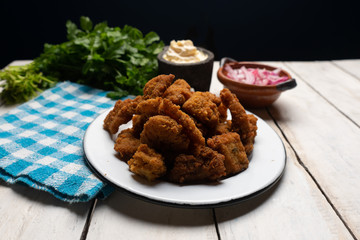 Fish chicharron with mayonnaise and onion on white background