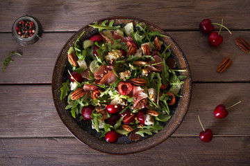 Strawberry and prosciutto salad with gorgonzola cheese and arugula. Healthy food. Overhead...