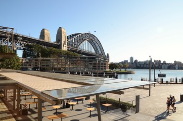 Campbells Cove, showing Sydney Harbour, Harbour Bridge, empty restaurant and joggers looking over...