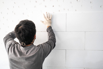 installation of gypsum boards on the wall in the apartment