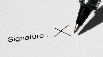 People signing a document with a cross or X mark letter : illiteracy concept