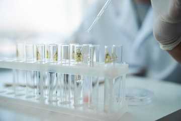 Caucasian scientist taking a sample of liquid