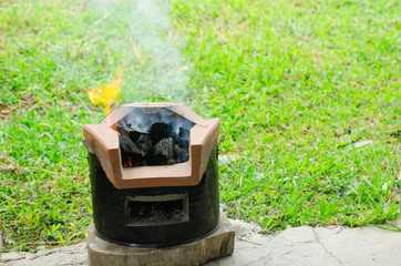 Charcoal and wood fire stove isolated from white background.