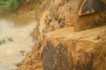 rough background texture of the natural stone is a pattern of brown stone lined vertically.