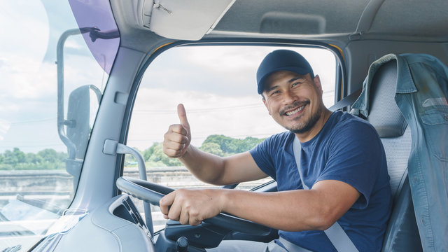 Happy smiling of professional truck driver in a long transportation and delivery