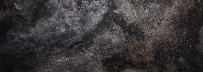 Panoramic background - old dark concrete wall with cracks