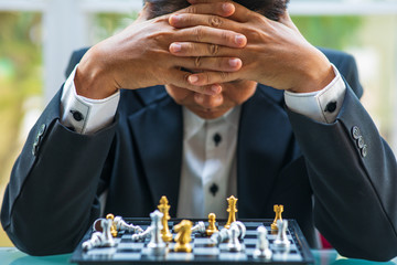 The senior business playing chess with failure