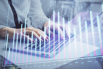 Fototapeta na wymiar Multi exposure of woman hands typing on computer and financial graph hologram drawing. Stock market analysis concept.