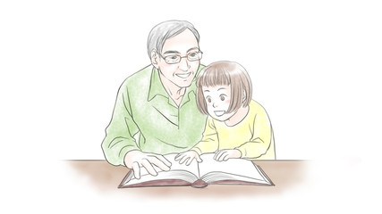 A senior man reading a book for his granddaughter