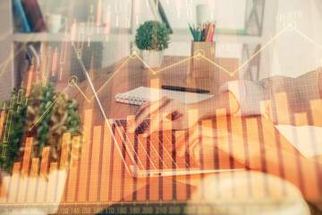 Double exposure of woman hands typing on computer and forex chart hologram drawing. Stock market invest concept.