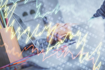Double exposure of woman hands typing on computer and forex chart hologram drawing. Stock market invest concept.