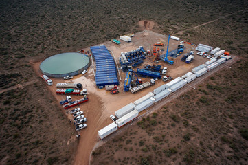 Vaca Muerta, Argentina, July 30, 2013: Extraction of unconventional oil. Battery of pumping trucks for hydraulic fracturing (Fracking).