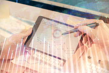 Double exposure of man's hands holding and using a phone and financial chart drawing. Market analysis concept.