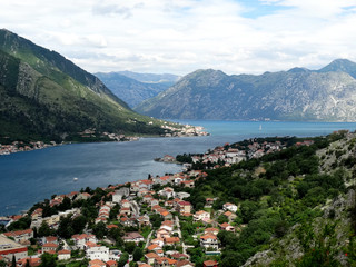 Fototapeta premium Aerial view of Kotor bay and old city in Kotor, Montenegro. Kotor is a coastal town in a secluded Gulf of Kotor, its preserved medieval old town is an UNESCO World Heritage Site. 