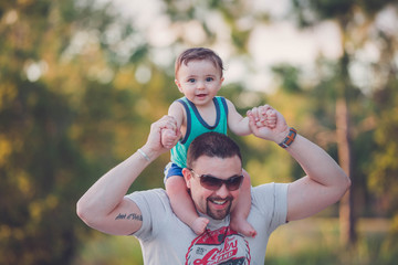 dad and son playing a park. 