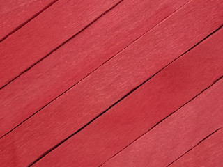 Background of red popsicle sticks with diagonal view.