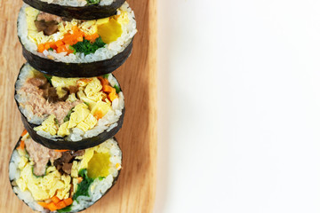 Korean kimbab on wooden board, top view copy space