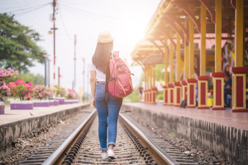  Young asian gril walking at train station before travel. work and travel concept.